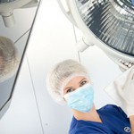 Worker cleaning health-care equipment