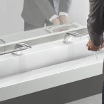 Closeup of sink with touchless faucet system