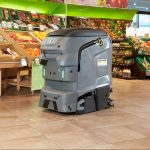 Robotic scrubber dryer cleaning a grocery store floor