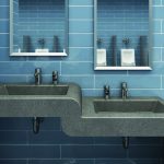 Grey 2-level sinks in restroom with light blue tile