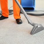 Worker cleaning carpet