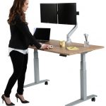 Female worker by a Howard Miller SmartMoves custom adjustable-height desk