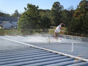 Figure 3. Installation of a liquid-applied roof coating. (From Facility Engineering Associates)