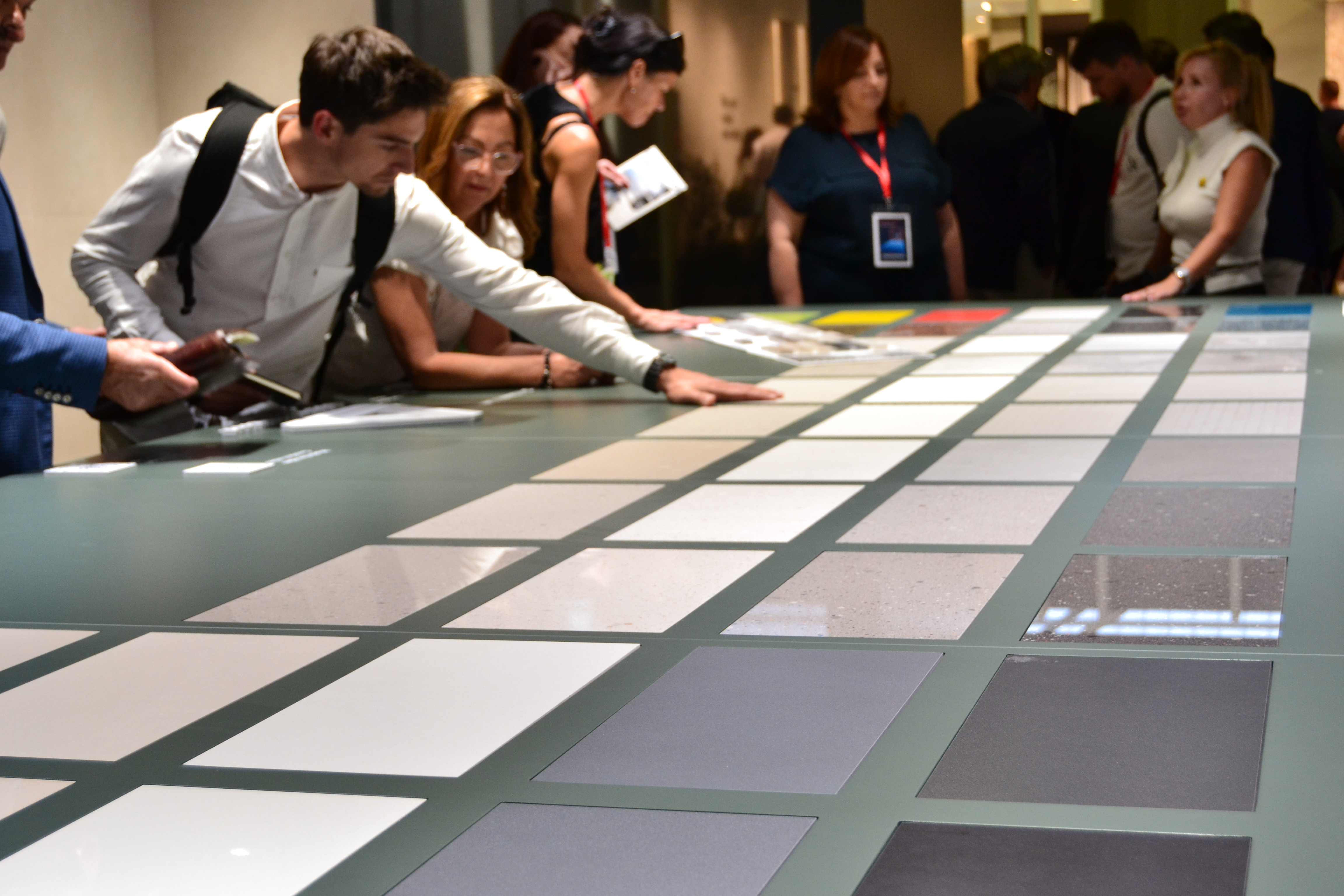 CERSAIE event: people looking at a table full of tiles