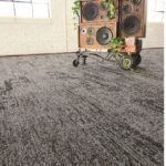 Milliken Major Frequency carpet tiles dark gray with whimsical wooden speaker set