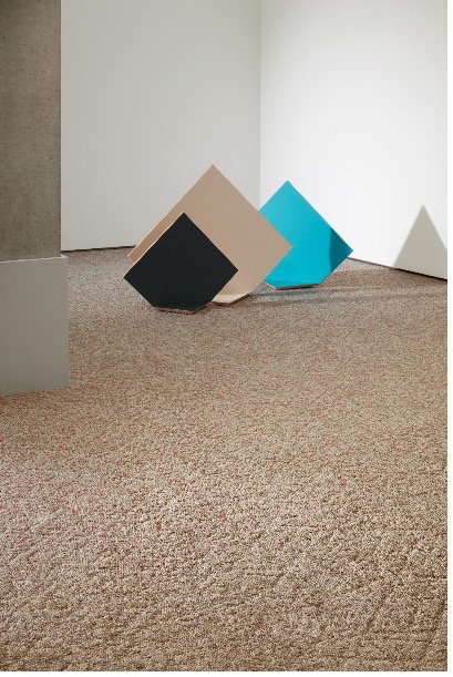 Tan Milliken Sculpture Forms carpet tiles with multicolored square shapes