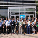 Attendees of the Wells Fargo Innovation Incubator (IN²) for cleantech acceleration pose for a group photo outside the Research Support Facility