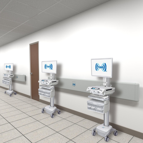 TAG-X Smart Rail - 3 medical carts lined up by handrails to charge wirelessly in a healthcare facility