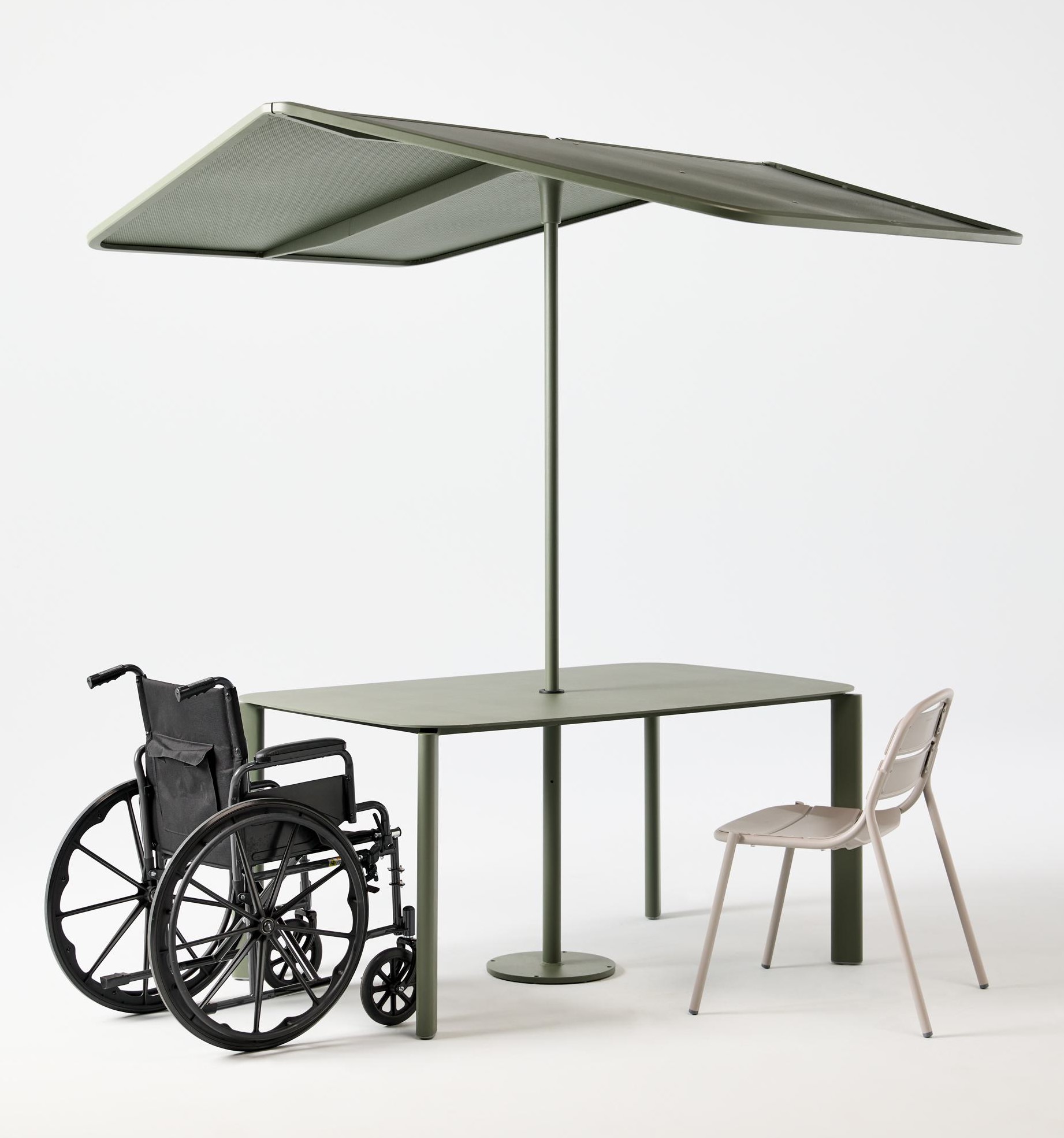 Table with shade, with wheelchair and regular chair next to it