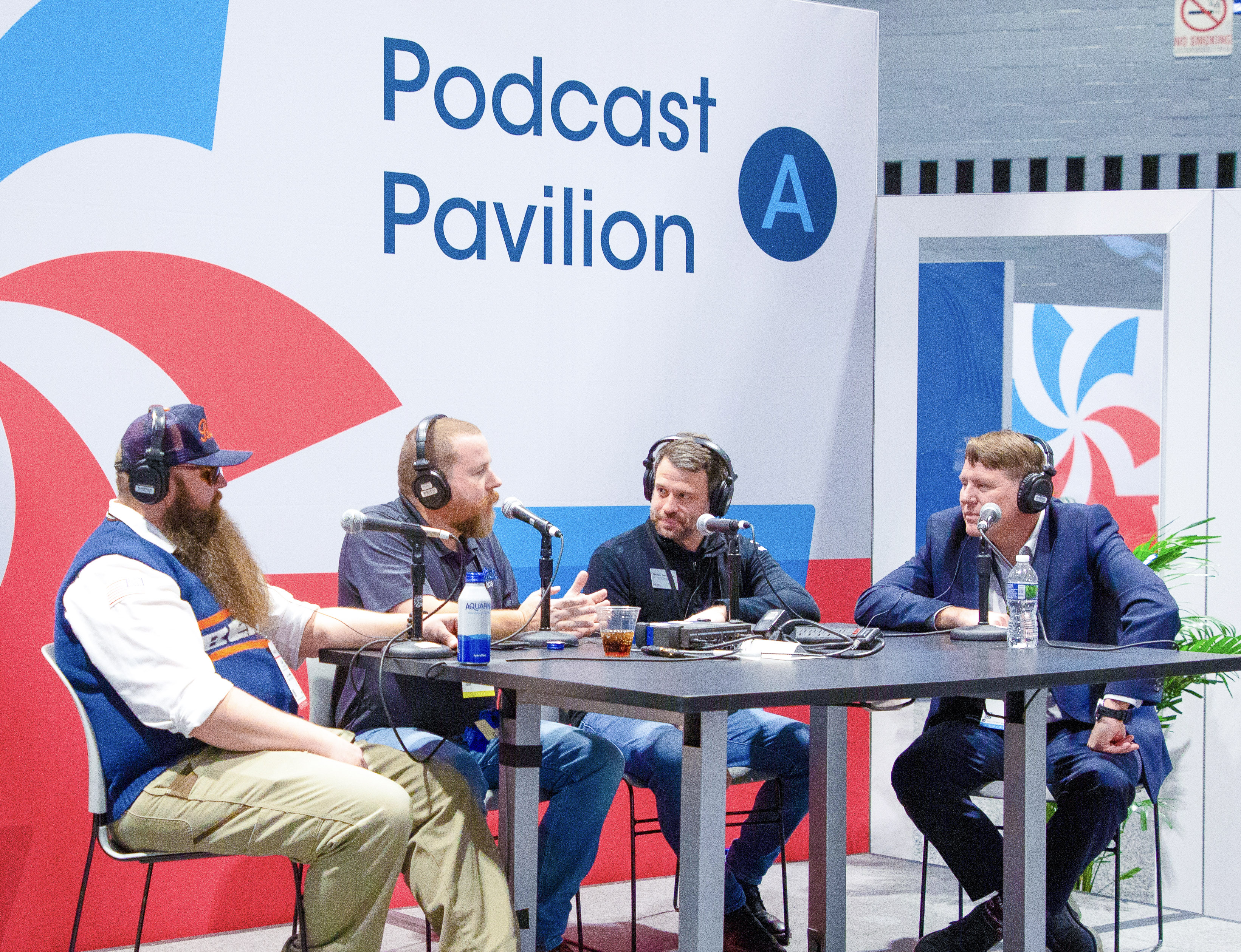 AHR Expo 2025 Orlando Podcast Pavilion session with 4 speakers at table with microphones