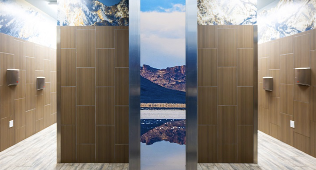 "America's Best Restroom" Maverick restroom interior with wood-grain panels and mountain scenes