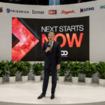 Rheem's Chris Peel in front of "Next Starts Now" sign