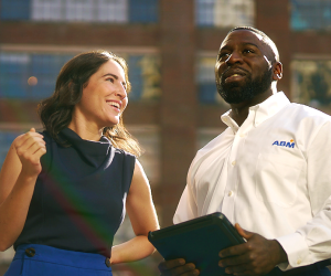 Woman speaking with man in ABM Performance Solutions uniform